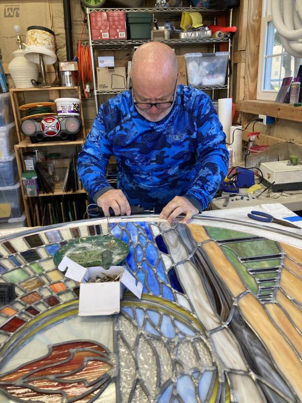 Ron Parks works on bending the piece’s zinc frame. SUBMITTED PHOTO